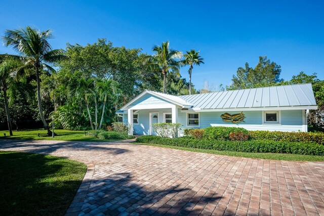 2897 SE Saint Lucie Blvd, Stuart, FL 34997 - ranch-style house featuring a standing seam roof and metal roof