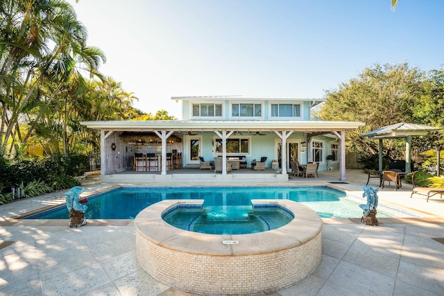 2897 SE Saint Lucie Blvd, Stuart, FL 34997 - view of pool featuring a patio, a ceiling fan, outdoor lounge area, and a pool with connected hot tub