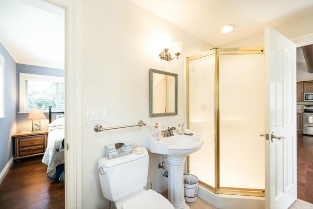 2897 SE Saint Lucie Blvd, Stuart, FL 34997 - bathroom with a stall shower, ensuite bath, wood finished floors, and toilet