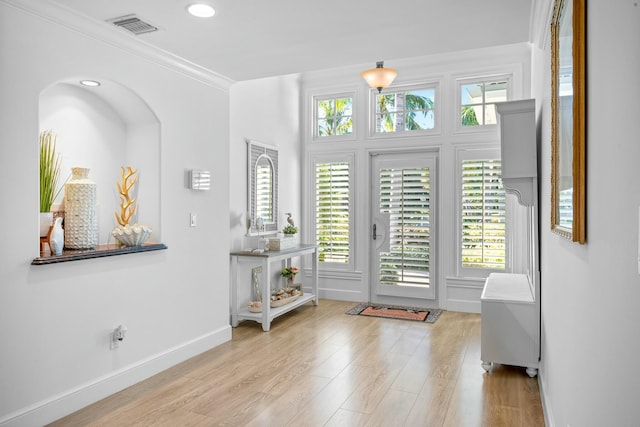2897 SE Saint Lucie Blvd, Stuart, FL 34997 - foyer with ornamental molding, visible vents, a healthy amount of sunlight, and wood finished floors
