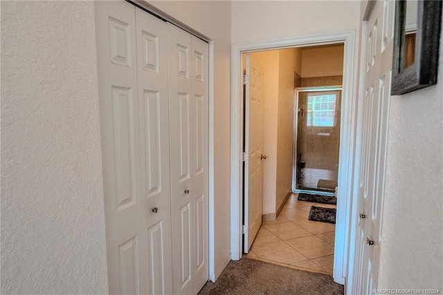 hallway featuring light tile patterned floors