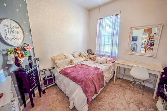 bedroom featuring light colored carpet