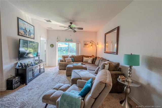 carpeted living room featuring ceiling fan