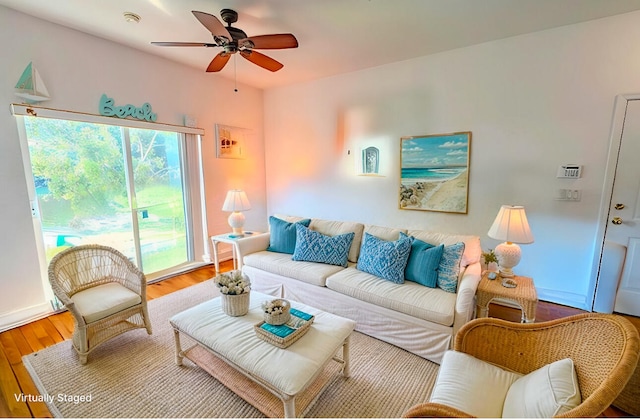 living room featuring wood-type flooring and ceiling fan