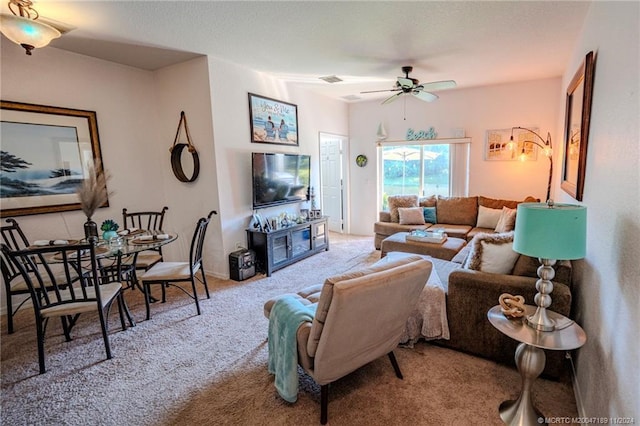 carpeted living room with ceiling fan