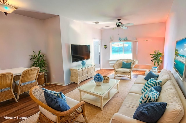 living room featuring wood-type flooring and ceiling fan