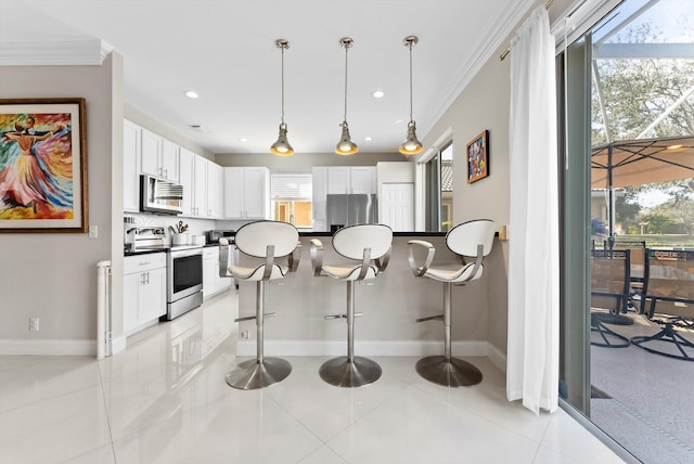 kitchen with appliances with stainless steel finishes, white cabinets, and light tile patterned flooring