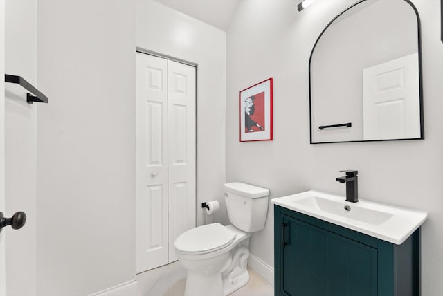 bathroom with vanity, tile patterned flooring, and toilet