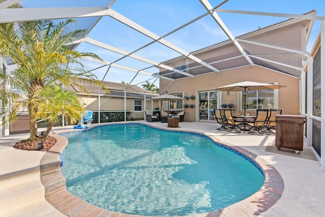 view of pool featuring a patio and glass enclosure