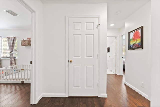 hallway with dark wood-type flooring