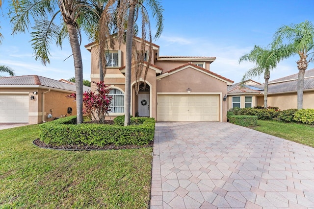 mediterranean / spanish-style house with a front lawn and a garage