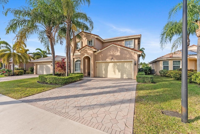 mediterranean / spanish-style house with a front lawn and a garage