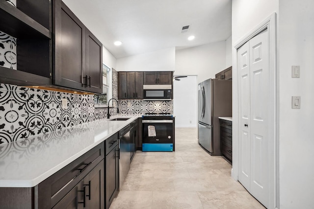 kitchen featuring black appliances, lofted ceiling, sink, backsplash, and dark brown cabinets