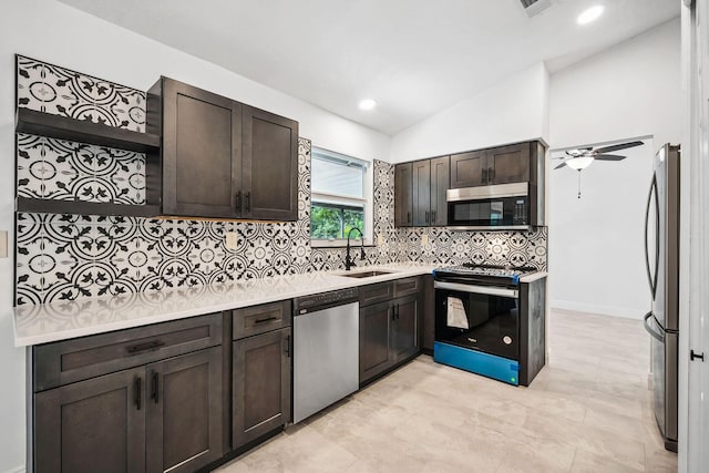 kitchen with appliances with stainless steel finishes, sink, vaulted ceiling, ceiling fan, and dark brown cabinets