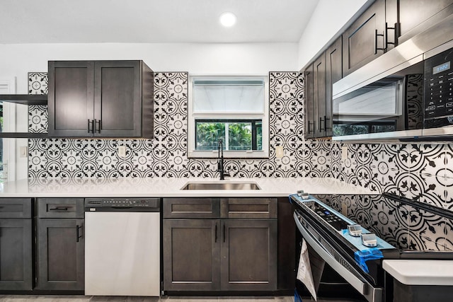 kitchen with tasteful backsplash, sink, stainless steel appliances, and dark brown cabinetry