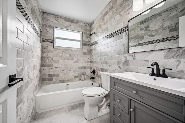 full bathroom featuring toilet, tiled shower / bath, tile walls, and vanity