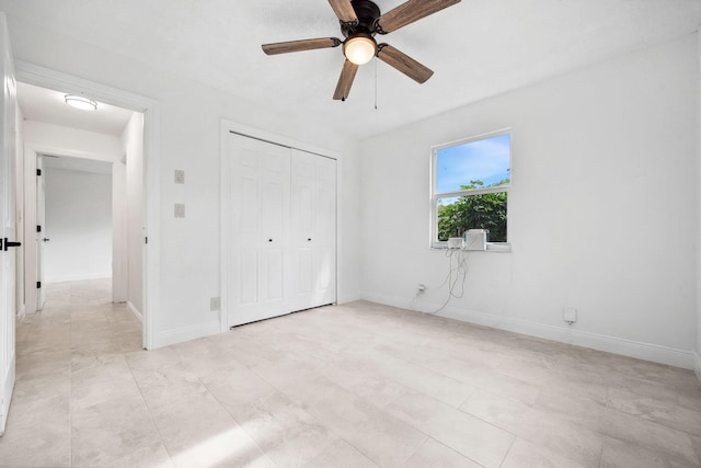 unfurnished bedroom with ceiling fan and a closet