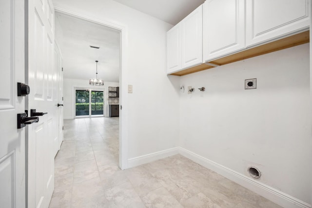 washroom with washer hookup, cabinets, a notable chandelier, and electric dryer hookup