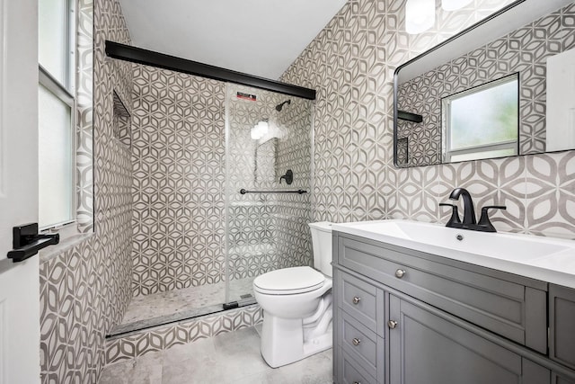 bathroom with toilet, vanity, and an enclosed shower