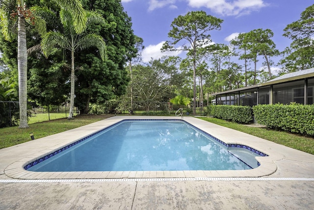 view of swimming pool featuring a sunroom