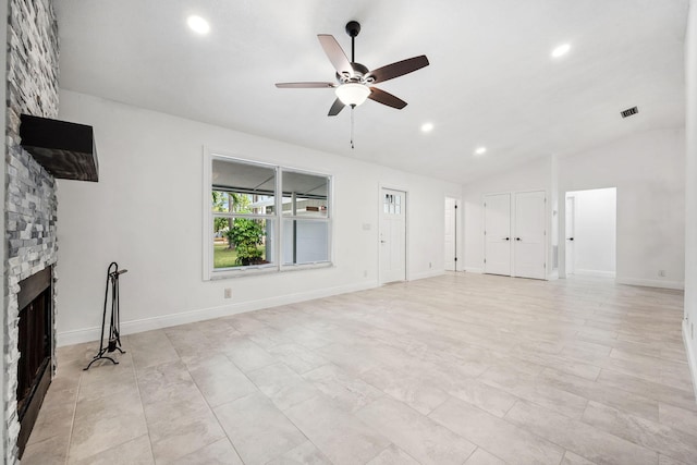 unfurnished living room with ceiling fan, a fireplace, and lofted ceiling