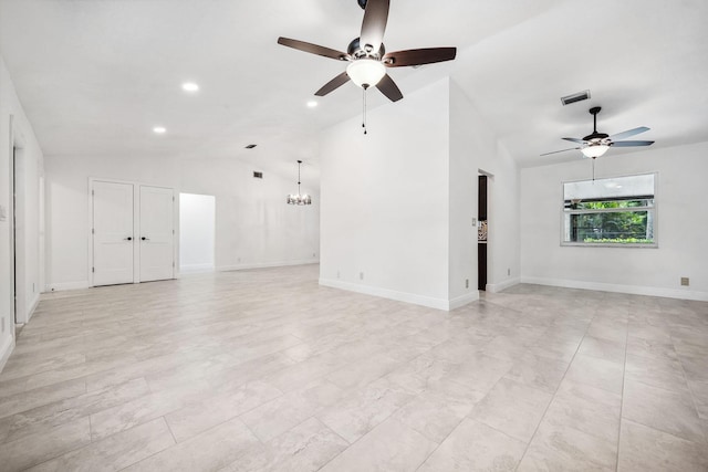 unfurnished living room with ceiling fan with notable chandelier and lofted ceiling