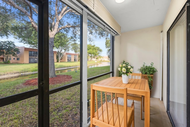 sunroom / solarium with a water view