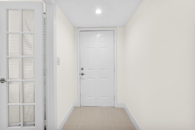 doorway with light tile patterned floors