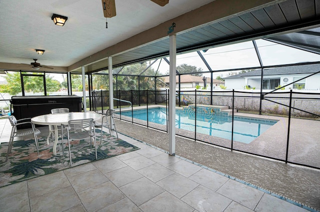 view of swimming pool featuring a lanai, a patio area, a hot tub, and ceiling fan