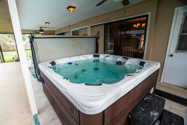 view of patio featuring ceiling fan and a hot tub