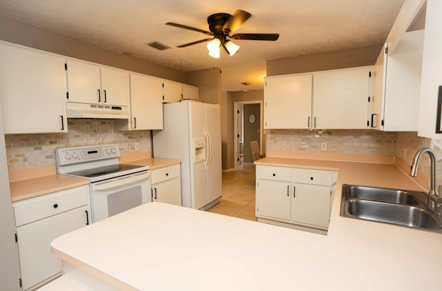 kitchen with white cabinetry, white appliances, and sink