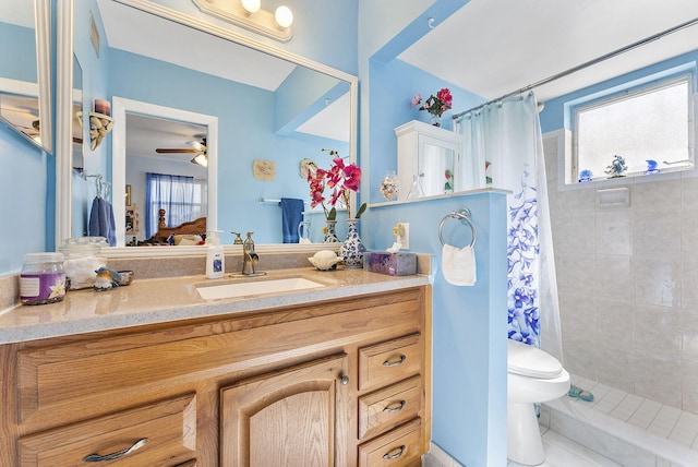 bathroom featuring vanity, tile patterned flooring, ceiling fan, toilet, and walk in shower