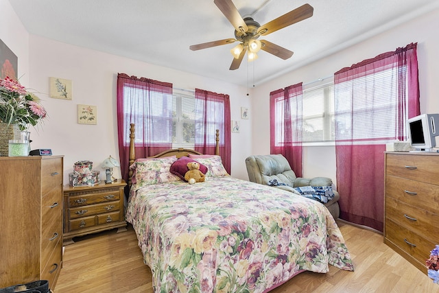 bedroom with ceiling fan and light hardwood / wood-style flooring