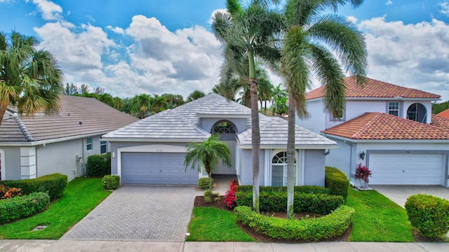 view of front of house featuring a garage and a front lawn