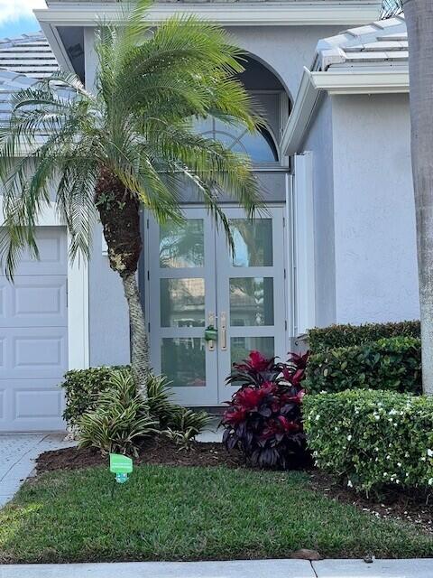 entrance to property with french doors and a garage