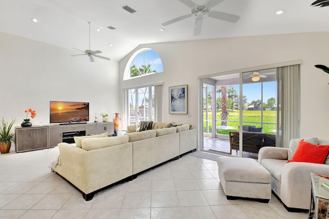 living room featuring lofted ceiling and light tile patterned floors