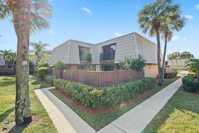 view of side of home featuring a lawn