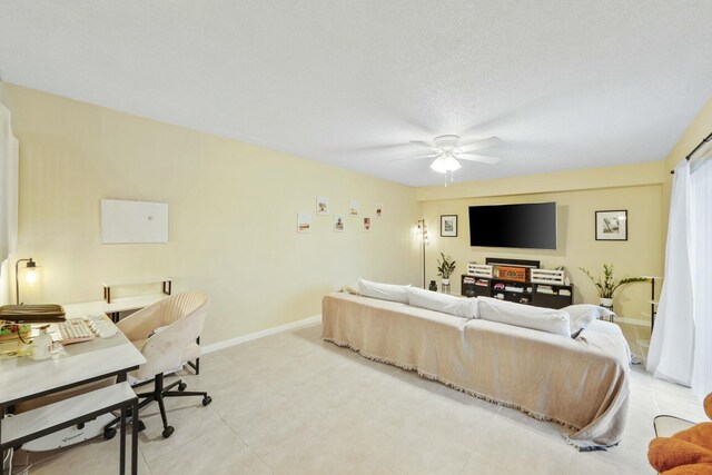 living room with a textured ceiling and ceiling fan