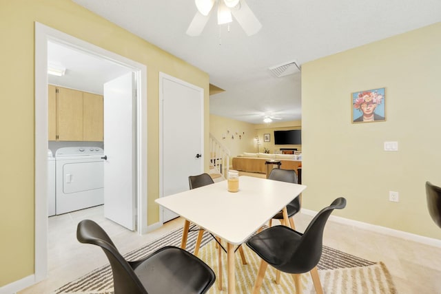 dining space with separate washer and dryer and ceiling fan