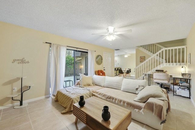 tiled living room featuring ceiling fan and a textured ceiling