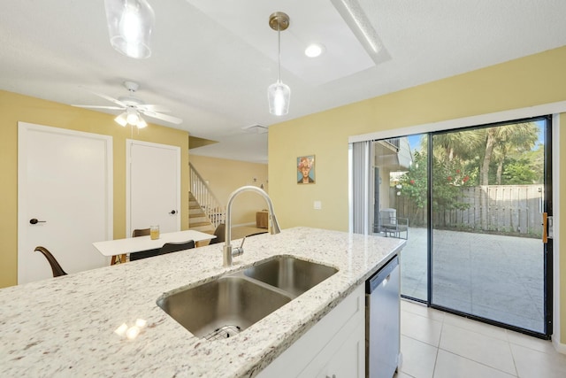 kitchen featuring stainless steel dishwasher, light stone countertops, sink, and pendant lighting