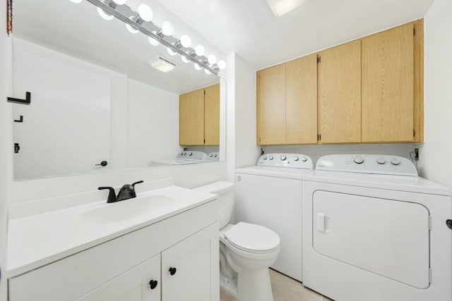 bathroom with washer and dryer, vanity, and toilet