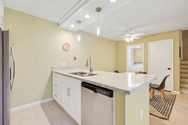 kitchen with stainless steel appliances, white cabinetry, sink, and kitchen peninsula