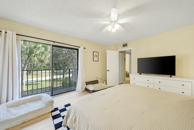 bedroom with access to outside, a textured ceiling, ceiling fan, and light hardwood / wood-style flooring