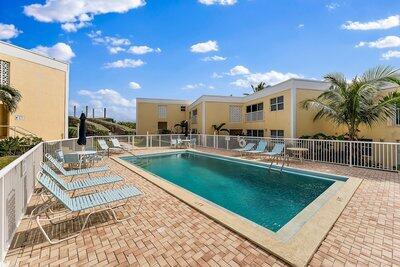 community pool featuring a patio and fence