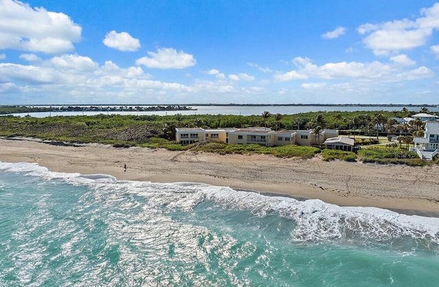 aerial view with a water view and a beach view