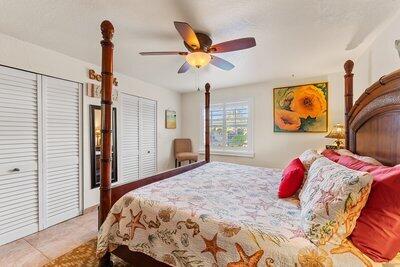 bedroom featuring two closets and ceiling fan