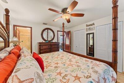 bedroom with two closets and a ceiling fan