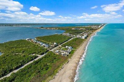 birds eye view of property with a view of the beach and a water view