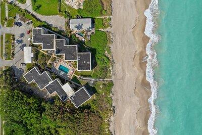 bird's eye view featuring a view of the beach and a water view